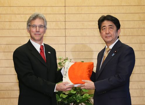 Photograph of the Prime Minister receiving a signed Good Luck Flag