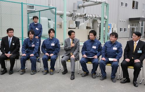 Photograph of the Prime Minister meeting with factory workers and others