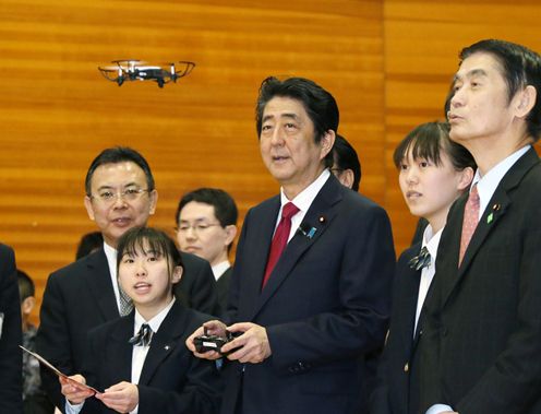 Photograph of the Prime Minister operating a drone at the robot and drone class