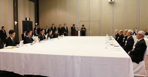 Photograph of the Prime Minister listening to requests by representatives of atomic bomb survivors