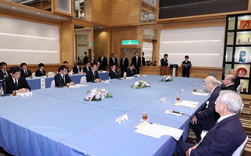 Photograph of the Prime Minister listening to requests from representatives of atomic bomb survivors