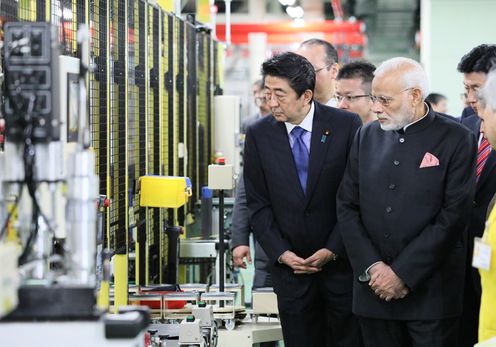 Photograph of the two leaders visiting a company