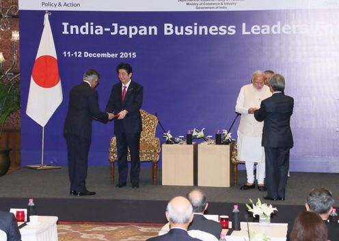 Photograph of the leaders receiving the joint report from the Business Leaders Forum