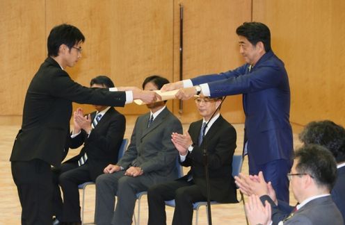 Photograph of the Prime Minister presenting a certificate of appreciation