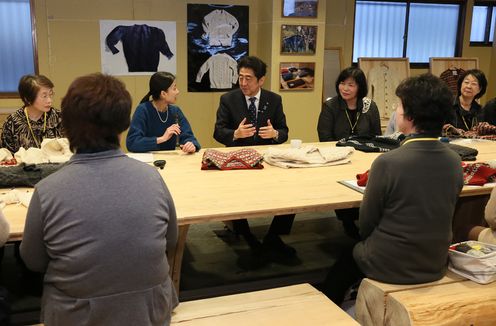 Photograph of the Prime Minister visiting makers of hand-knit items