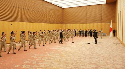 Photograph of the Prime Minister being given traditional scout cheers of 