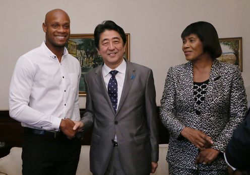 Photograph of the leaders conversing with athlete  Asafa Powell prior to the dinner banquet