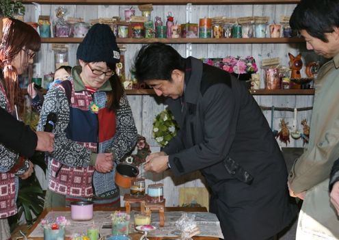 Photograph of the Prime Minister making a candle