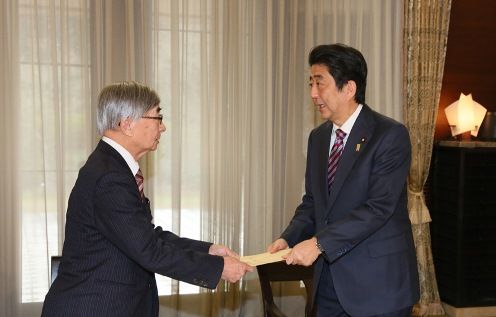 Photograph of the Prime Minister receiving documents and other items