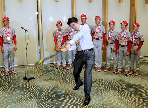 Photograph of the Prime Minister swinging a bat