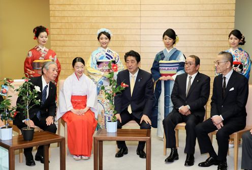Photograph of the Prime Minister being presented with Kurume camellias