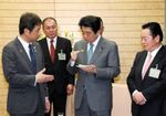 Photograph of the Prime Minister being presented with hoshi imo