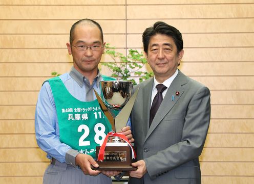 Photograph of the Prime Minister presenting a trophy