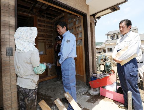 Photograph of the Prime Minister visiting a site affected by flooding