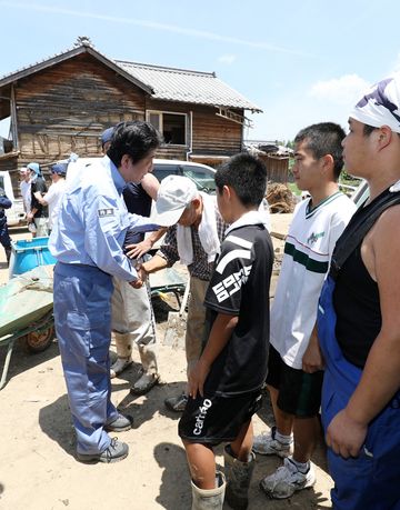 Photograph of the Prime Minister visiting a site affected by flooding