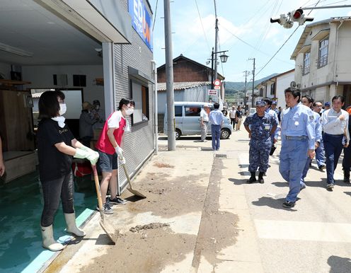 Photograph of the Prime Minister visiting a site affected by flooding