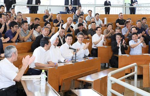 Photograph of the Prime Minister participating in the mock calf auction