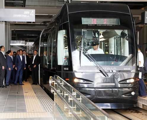 Photograph of the Prime Minister boarding a tram