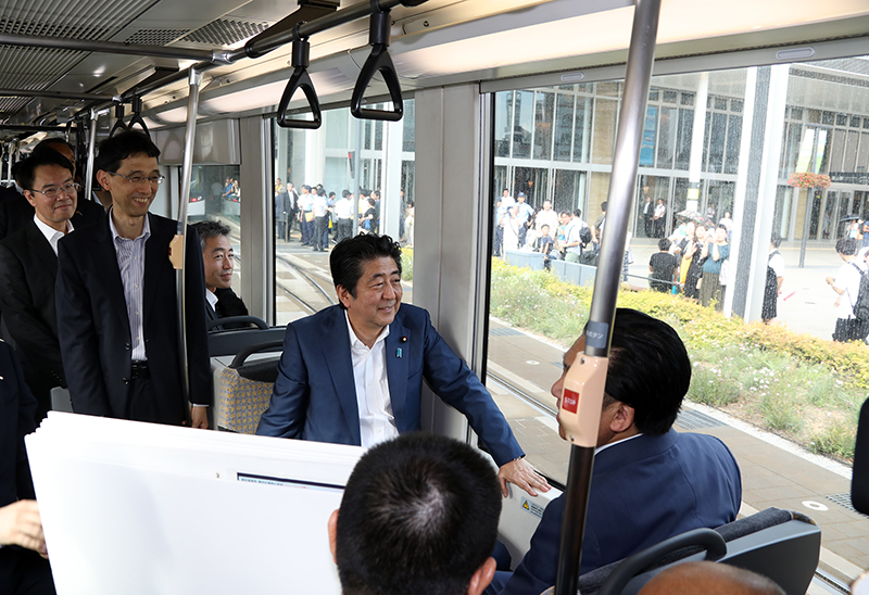 Photograph of the Prime Minister boarding a tram