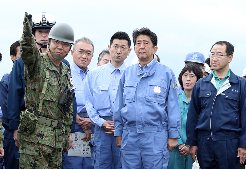 Photograph of the Prime Minister visiting a site affected by a landslide