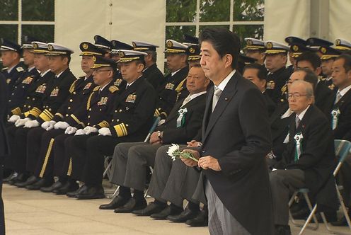 Photograph of the Prime Minister offering a flower