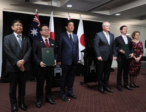 Photograph of the exchange of documents ceremony for Memoranda of Understanding