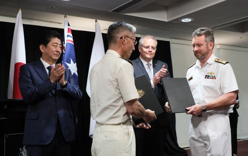 Photograph of the exchange of documents ceremony for Memoranda of Understanding