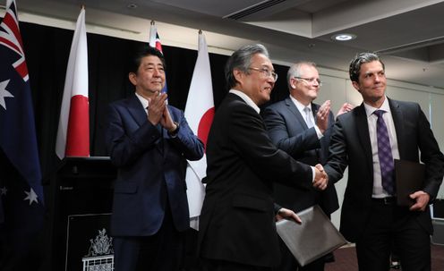 Photograph of the exchange of documents ceremony for Memoranda of Understanding