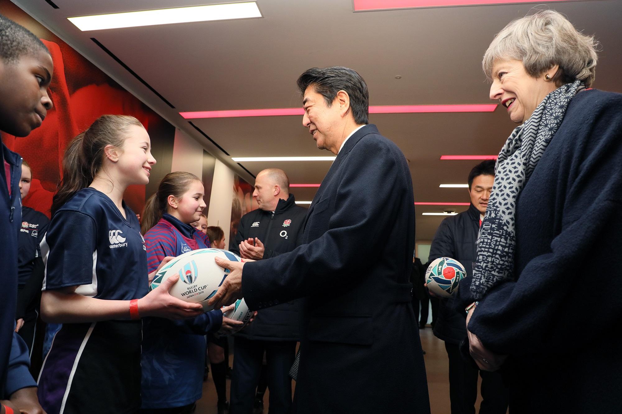 Photograph of the Prime Minister interacting with local children
