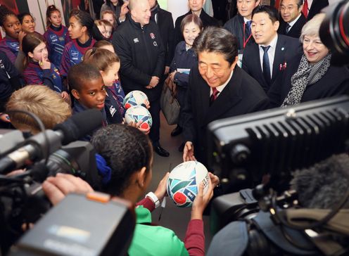 Photograph of the Prime Minister interacting with local children