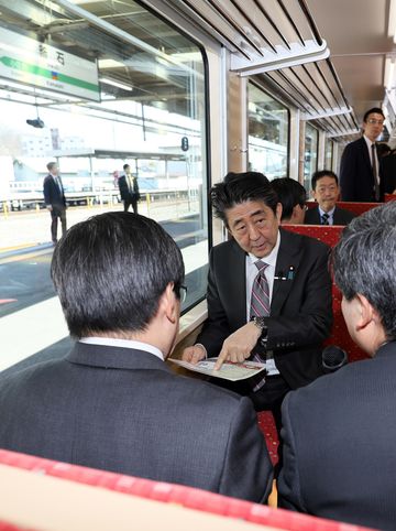 Photograph of the Prime Minister observing the train car trial run