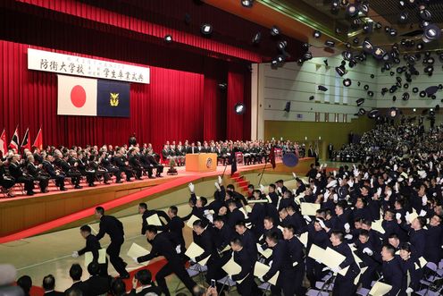 Photograph of the Prime Minister looking over the graduates