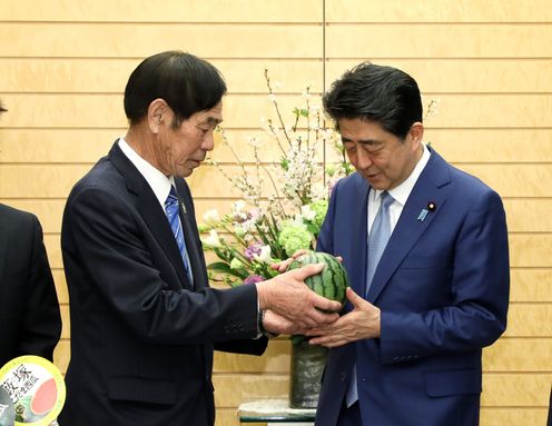 Photograph of the Prime Minister being presented with the watermelon