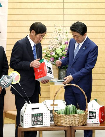 Photograph of the Prime Minister being presented with the watermelon