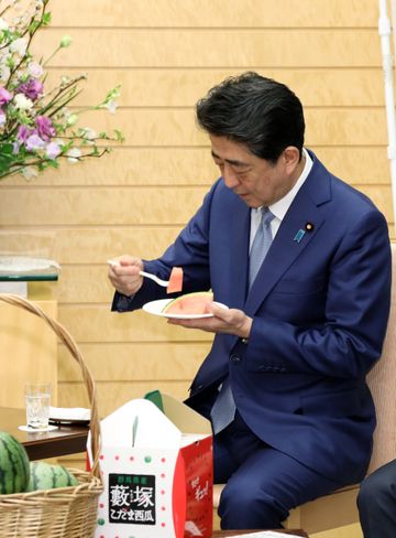 Photograph of the Prime Minister being presented with the watermelon