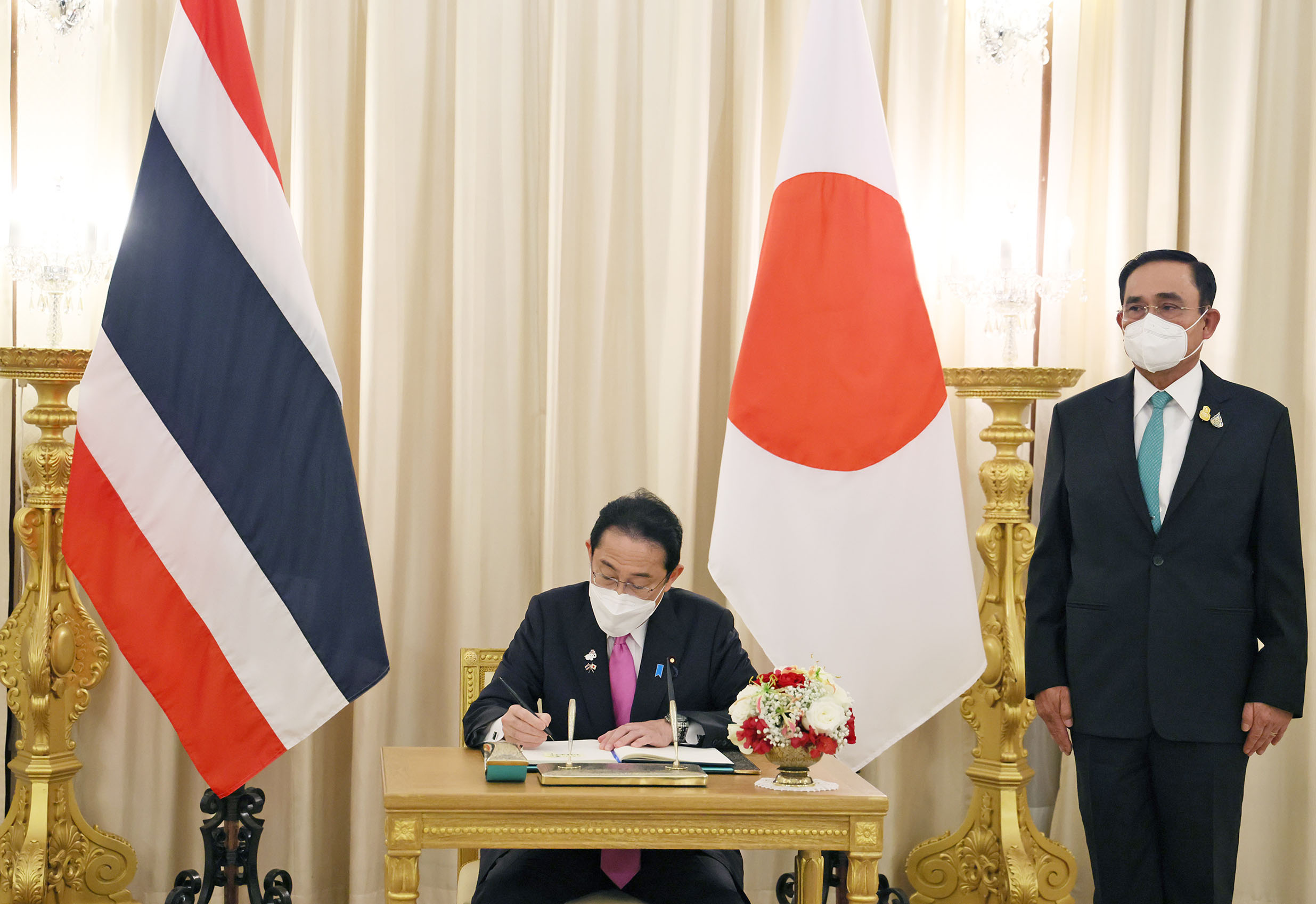 Photograph of the Prime Minister signing a visitors’ book