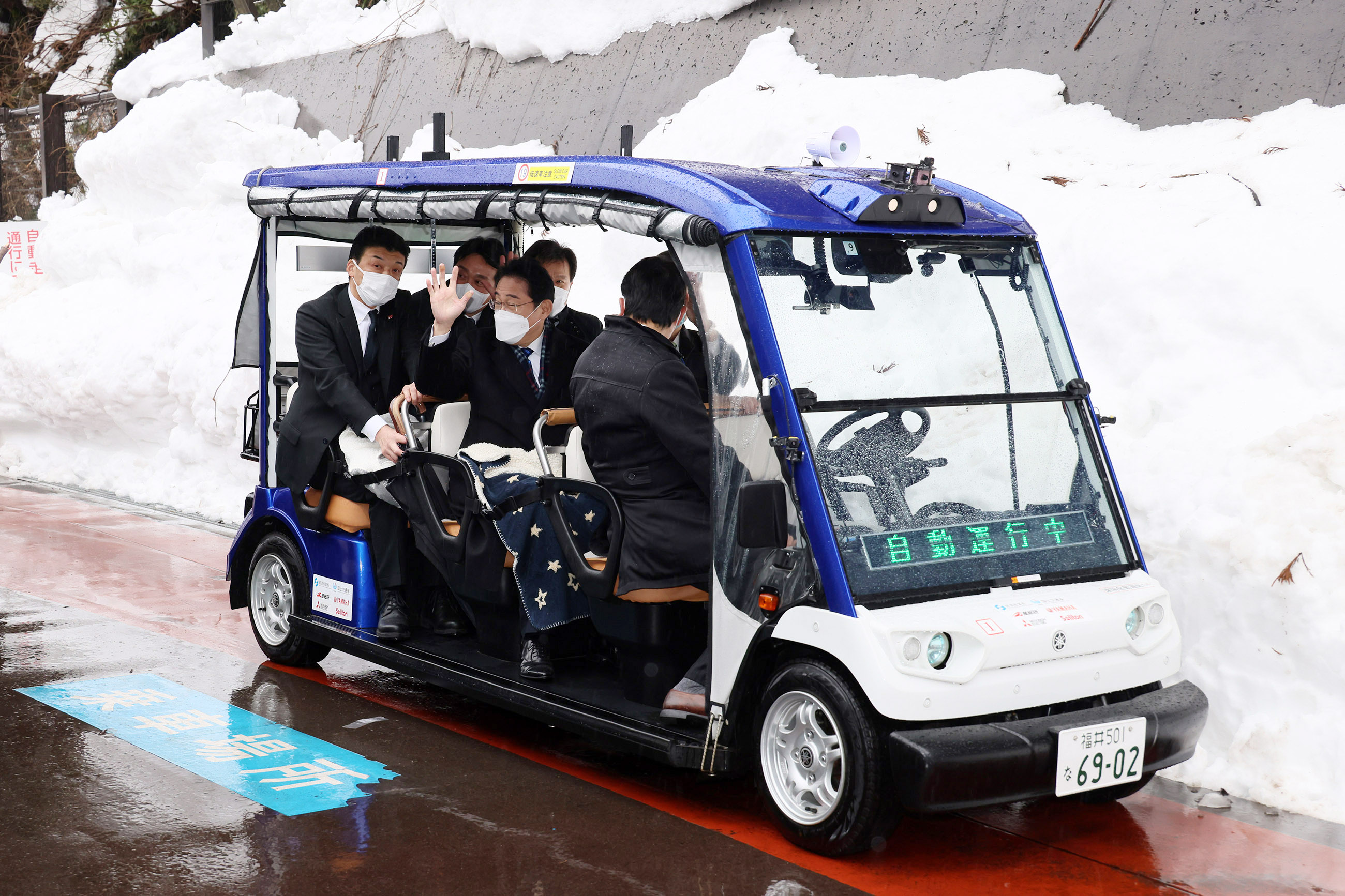 Prime Minister Kishida taking a test ride on a self-driving vehicle