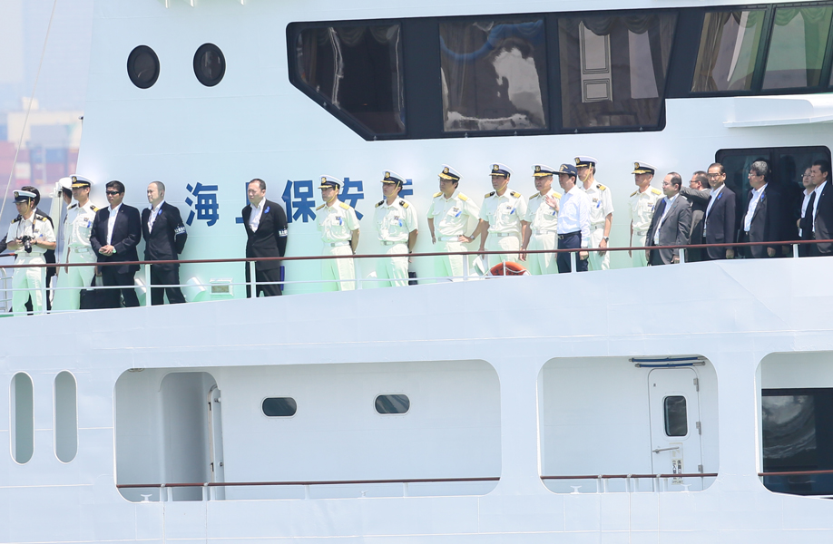 Photograph of the Prime Minister observing drills from aboard a ship