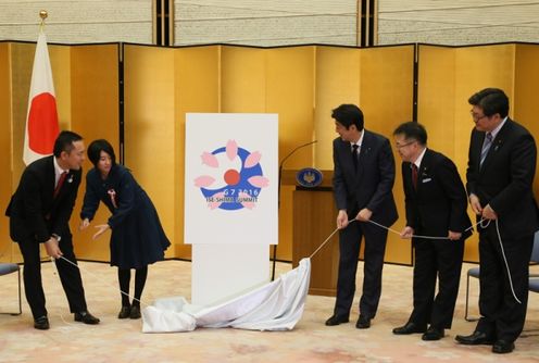 Photograph of the unveiling of the official logo