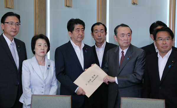 Photograph of the Prime Minister receiving a document
