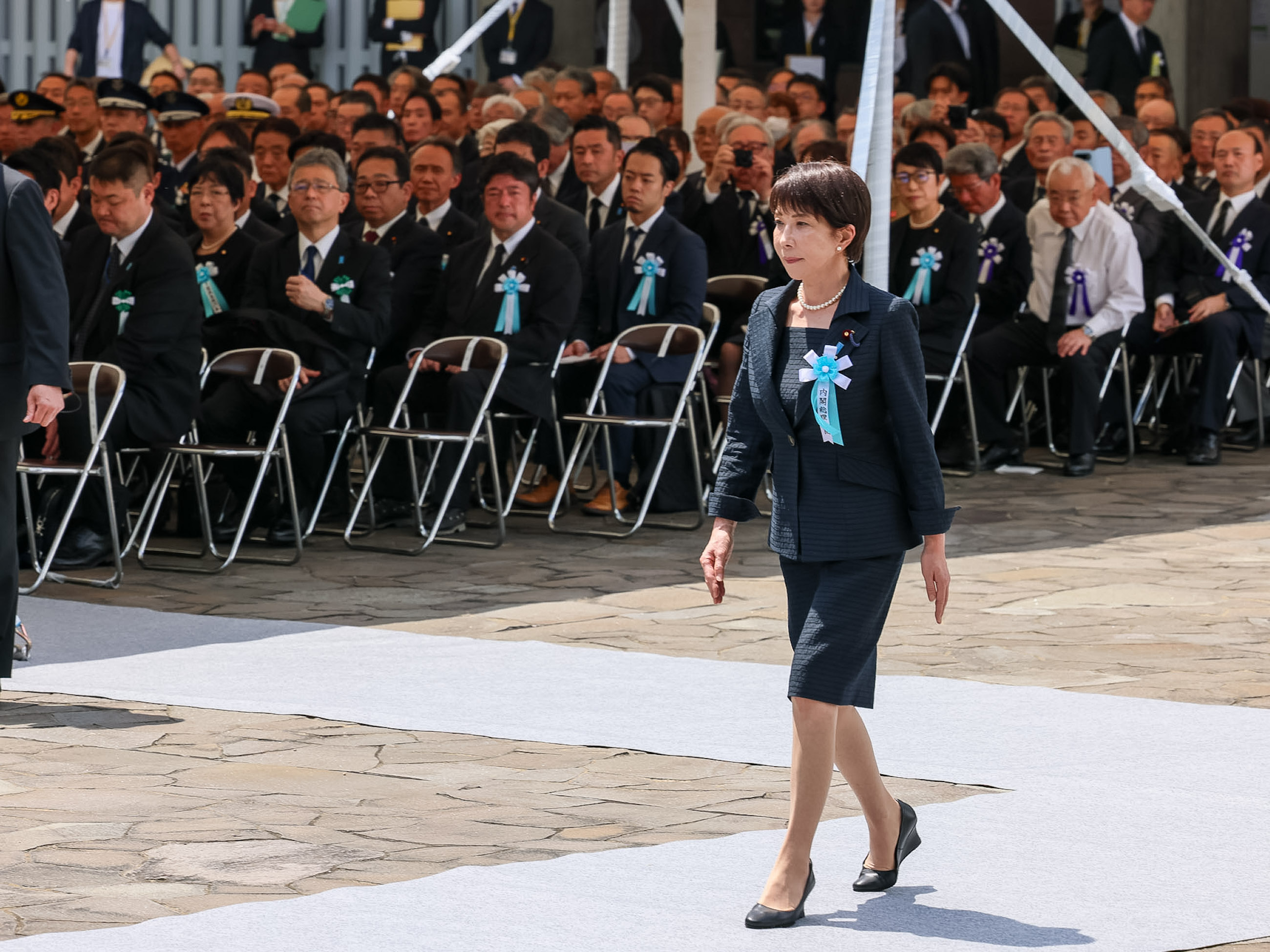 Prime Minister Takaichi offering a flower (2)
