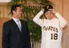 Photograph of Mr. Kuwata presenting Prime Minister Hatoyama with a cap and uniform