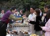 Photograph of the Prime Minister enjoying a barbeque with the participants of the 