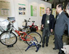 Photograph of the Prime Minister observing an energy generating bicycle at Eco-Products 2007