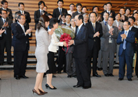Photograph of the Prime Minister receiving flowers from the staff at the Prime Minister's Office