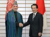 Photograph of Prime Minister Kan shaking hands with President Karzai