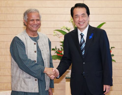 Photograph of the Prime Minister shaking hands with President of Grameen Bank Muhammad Yunus