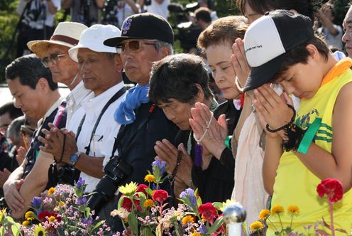 Photograph of participants offering a silent prayer at the Hiroshima Peace Memorial Ceremony