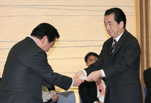 Photograph of the Prime Minister receiving a report at the meeting of the Tax Commission