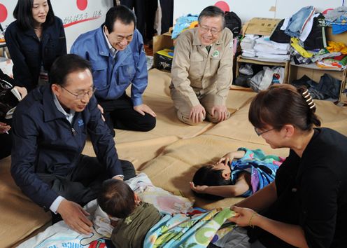 Photograph of Prime Minister Kan and President Lee greeting people at the evacuation center